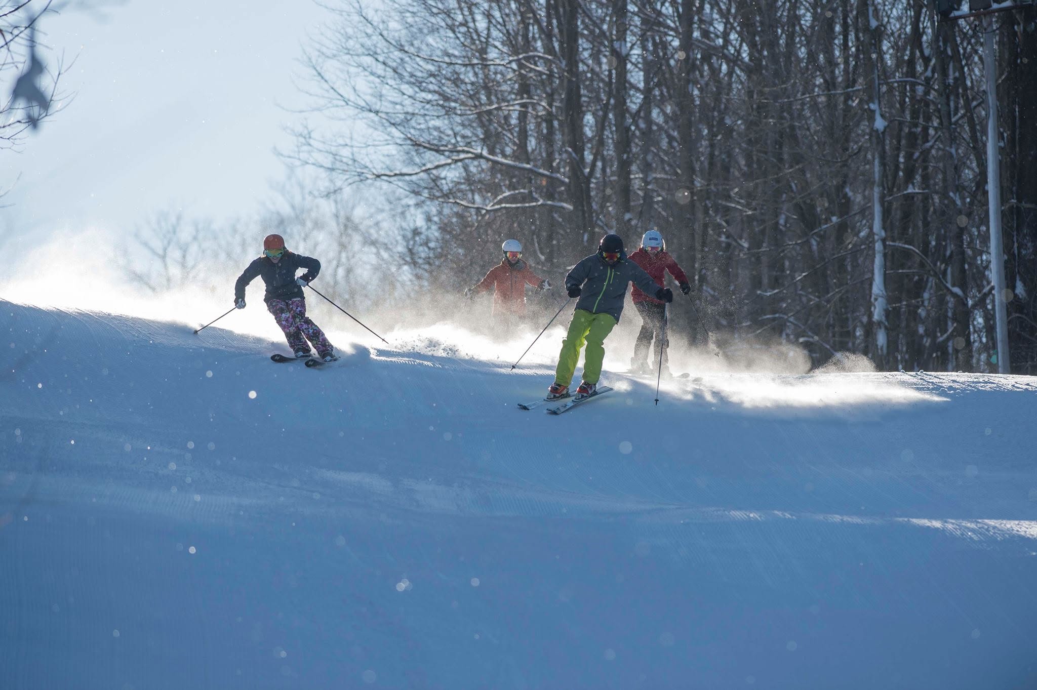 Skiers on a groomed run at Ellicottville